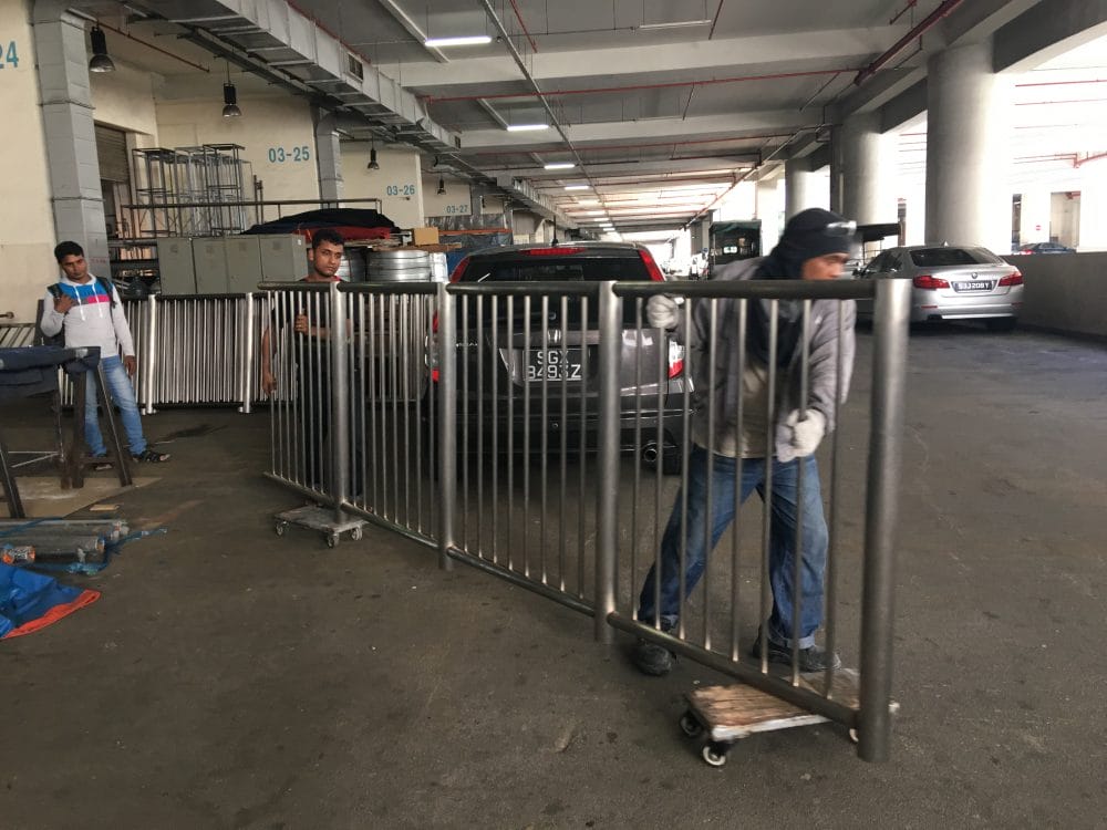 Workers moving the stainless steel railings from Brooklynz