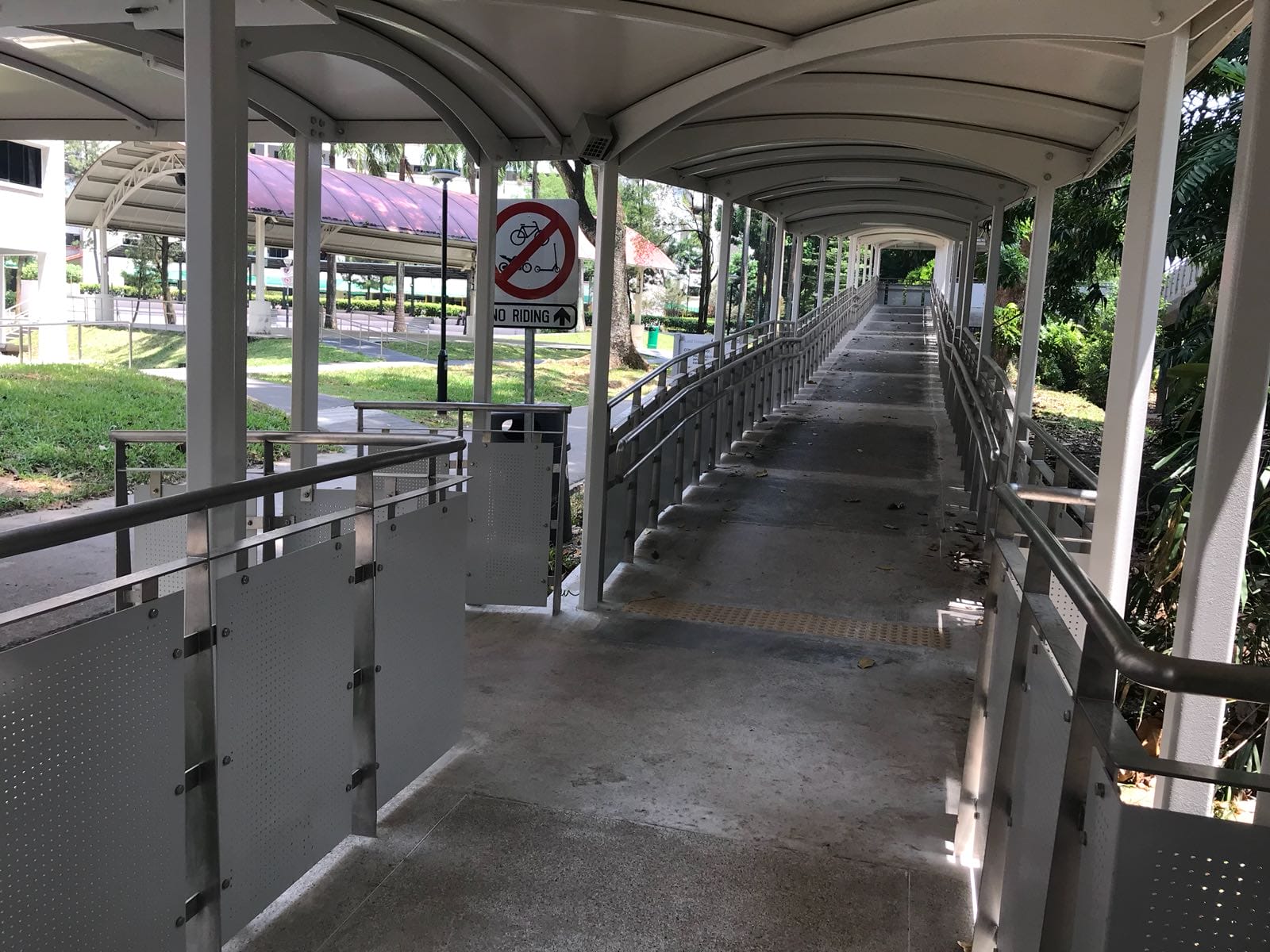 Sheltered walkway with durable stainless steel metal railing in Singapore developed by Brooklynz