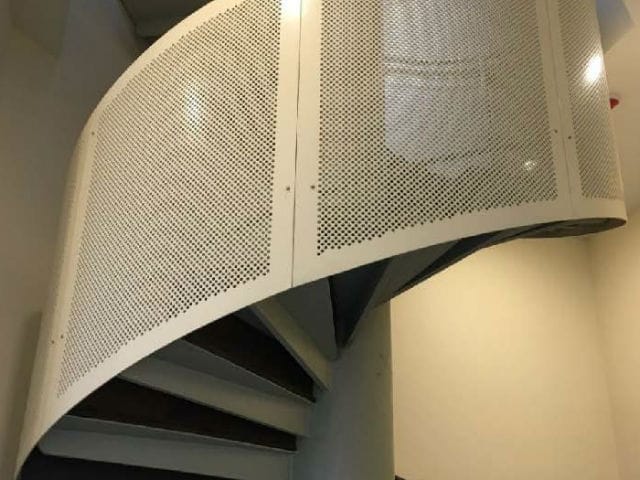 Close up shot of metal work railing with custom aluminum panel of a spiral staircase by Brooklynz Singapore