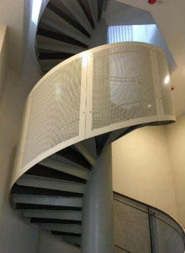 Metal work railing with custom aluminum panels at spiral stairs by Brooklynz Singapore