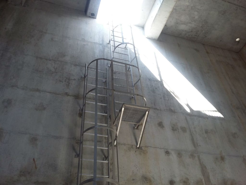 Securely fastened vertical fixed aluminium cat ladder in a building by Brooklynz supplier Singapore